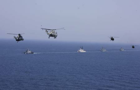 Warships and military helicopters attend the AMAN 09 military exercises at the Arabia Sea off the southern Pakistani port of Karachi, on Mar. 9, 2009. Warships from participating countries Monday began their second phase of the two-week-long AMAN 09 military exercises at the Arabia Sea off the southern Pakistani port of Karachi. (Xinhua/Zha Chunming)