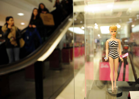 A Barbie doll wearing a zebra-print swimming suit is displayed during an exhibition at a shopping center in New York, the United States, on March 9, 2009. The exhibition held here displayed 120 Barbie dolls of 6 series to celebrate Barbie's 50th birthday. (Xinhua/Shen Hong)