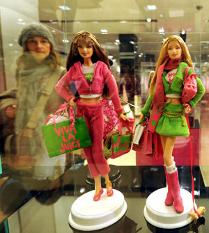  A visitor looks at the Barbie dolls displayed during an exhibition at a shopping center in New York, the United States, on March 9, 2009. The exhibition held here displayed 120 Barbie dolls of 6 series to celebrate Barbie's 50th birthday. (Xinhua/Shen Hong)