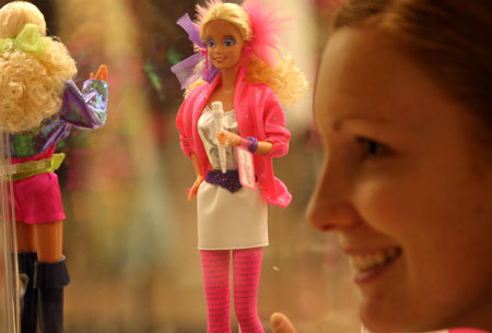 A girl poses with Barbie dolls at the Bloomingdale shopping center in New York, March 9, 2009. The Barbie doll which debuted on March 9, 1959, celebrated its 50th anniversary worldwide on Monday. (Xinhua/Liu Xin) 
