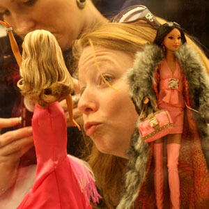 A girl poses with Barbie dolls at the Bloomingdale shopping center in New York, March 9, 2009. The Barbie doll which debuted on March 9, 1959, celebrated its 50th anniversary worldwide on Monday. (Xinhua/Liu Xin) 