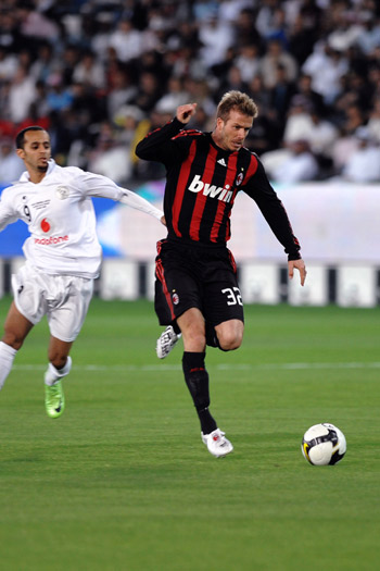 AC Milan's David Beckham (R) kicks the ball during the soccer match against Al-Sadd at the Jassim Bin Hamad stadium in Doha, Qatar, March 4, 2009. Alexandre Pato and Luca Antonini scored Wednesday to give AC Milan a 2-1 win over Qatar's Al-Sadd in the friendly.[Xinhua]