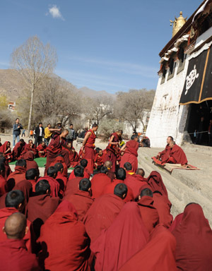 Tibetan lamas attend a debate about the sutra of Tibetan Buddhism at the Sera Monastery during the Grand Summons Ceremony in the suburb of Lhasa, southwest China's Tibet Autonomous Region, on March 10, 2009. (Xinhua/Soinam Norbu) 