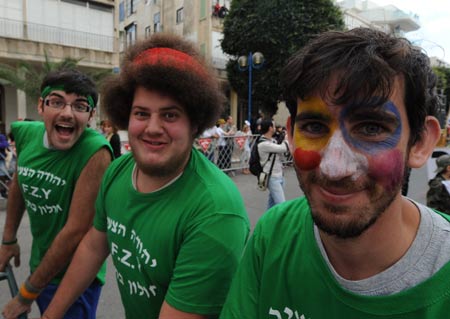 Young people attend the annual Purim Festival Parade in Holon, south of Tel Aviv, March 10, 2009. Jewish people celebrated their Purim Festival from March 10 to 11 this year. (Xinhua/Yin Bogu)