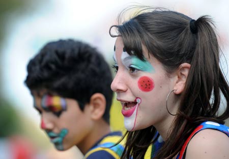 A girl and boy with face-painting of clown attend the annual Purim Festival Parade in Holon, south of Tel Aviv, March 10, 2009. Jewish people celebrated their Purim Festival from March 10 to 11 this year. (Xinhua/Yin Bogu)