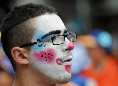 A boy with face-painting of clown attends the annual Purim Festival Parade in Holon, south of Tel Aviv, March 10, 2009. Jewish people celebrated their Purim Festival from March 10 to 11 this year. (Xinhua/Yin Bogu) 