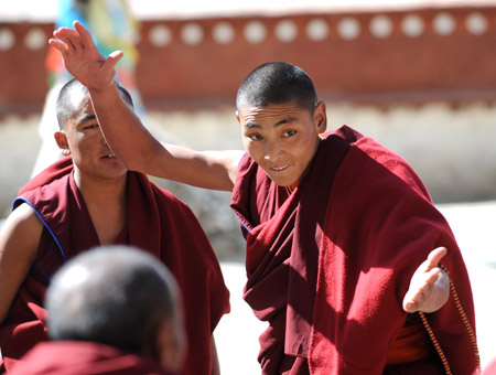 Tibetan lamas debate about the sutra of Tibetan Buddhism at the Sera Monastery during the Grand Summons Ceremony in the suburb of Lhasa, southwest China's Tibet Autonomous Region, on March 10, 2009. 