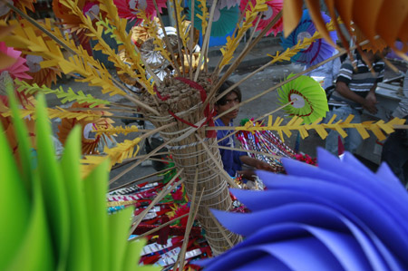 A boy sells decorations to mark Eid-e-Milad-ul-Nabi, or birthday celebrations of Prophet Mohammad, in the streets of Karachi March 10, 2009.