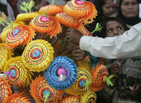 Well-wishers buy decorations to mark Eid-e-Milad-ul-Nabi, or birthday celebrations of Prophet Mohammad, in the streets of Karachi March 10, 2009.