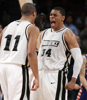 Providence University's Jonathan Kale (34) celebrates with teammate Geoff McDermott during the second half of their game against Depaul University at the 2009 NCAA Big East men's college basketball tournament in New York March 11, 2009. [Xinhua/Reuters]