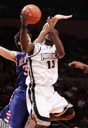 Providence University's Weyinmi Efejuku (13) drives to the basket on Depaul University's Matija Poscic in the first half of their game at the 2009 NCAA Big East men's college basketball tournament in New York March 11, 2009.