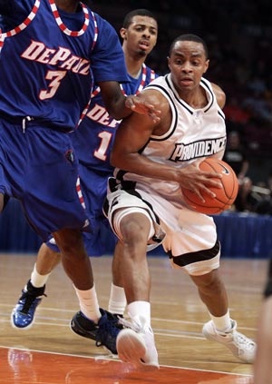 Providence University's Sharaud Curry (R) drives to the basket on Depaul University's Devin Hill (3) and Jeremiah Kelly (C, rear) in the first half of their game at the 2009 NCAA Big East men's college basketball tournament in New York March 11, 2009.