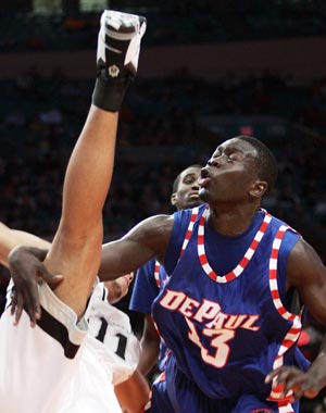 Providence University's Geoff McDermott (L) is fouled by Depaul University's Mac Koshwal (13) in the first half of their game at the 2009 NCAA Big East men's college basketball tournament in New York March 11, 2009.