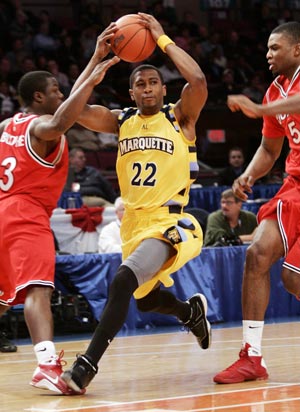 Marquette University's Jerel McNeal (22) drives to the basket against St. John's University defender Sean Evans (5) and Malik Boothe (3) in the first half of their game at the 2009 NCAA Big East men's college basketball tournament in New York March 11, 2009.