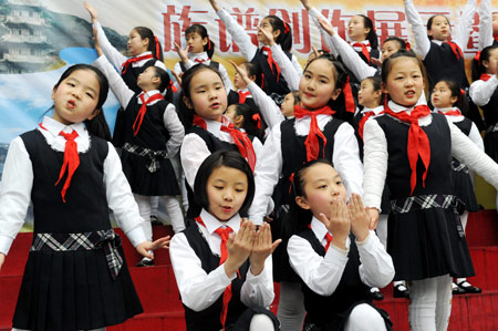 Pupils from two sides of the Taiwan Straits sing and dance at No. 1 Primary Schoool attached to Fuzhou Education College, where some Taiwanese children study, in Fuzhou, capital of southeast China's Fujian Province, Mar. 11, 2009. Pupils from two sides of the Taiwan Straits display their handmade genealogies to express the compatriots' affection on Wednesday. (Xinhua/Jiang Kehong) 