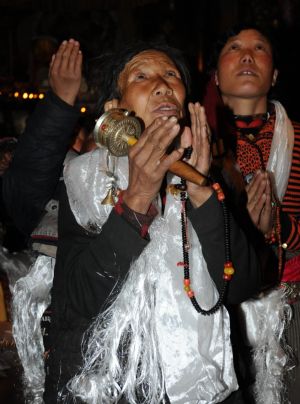 Believers worship the figures of Buddha in the Jokhang Temple in Lhasa, capital of southwest China's Tibet Autonomous Region, Mar. 11, 2009. A celebration for the ghee flowers and lanterns festival was held in the Jokhang Temple, attracting the visitors from all over the country. 