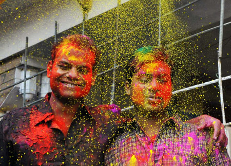 Indians get gulal (coloured power) smeared onto their faces during celebrations of Holi in New Delhi on March 11, 2009. Holi, also known as festival of colours, heralds the beginning of spring and is celebrated with great enthusiasm all over India. 