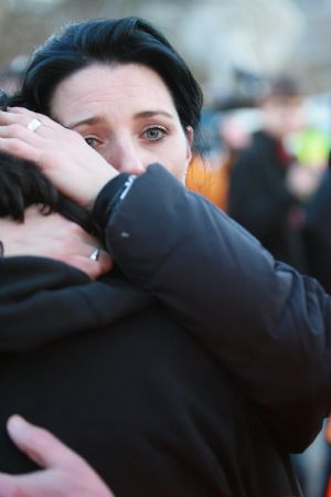 Relatives and friends of victims comfort each other outside the Albertville high school in the town of Winnenden near the southwestern German city of Stuttgart, March 11, 2009. The school schooting on Wednesday which killed 16 people including the 17-year-old gunman shocks Germany. German Chancellor Angela Merkel said that Wednesday is a day of sorrow for the whole of Germany. (Xinhua/Luo Huanhuan)