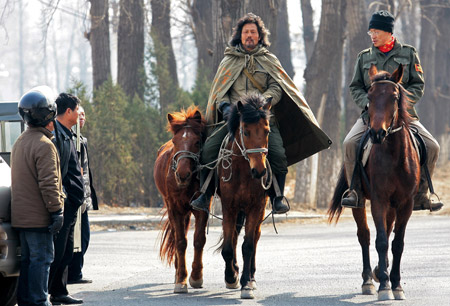 Chinese-Russian Li Jing (C) rides on his horse at Changping District of Beijing, capital of China, Mar. 10, 2009. (Xinhua/Zhou Guoqiang)