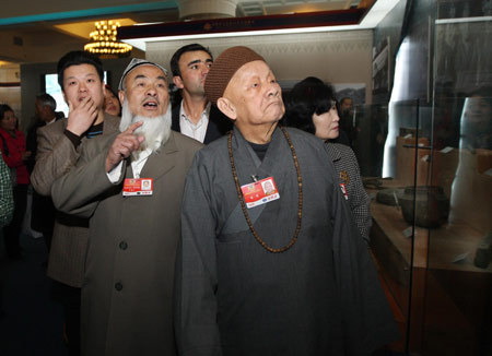 Some members of the 11th National Committee of the Chinese People's Political Consultative Conference (CPPCC), who are attending the Second Session of the 11th National Committee of the CPPCC, visit an exhibition titled 'Democratic Reform in the Tibet Autonomous Region' at the Cultural Palace of Nationalities in Beijing, capital of China, March 11, 2009. 