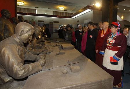 Some members of the 11th National Committee of the Chinese People's Political Consultative Conference (CPPCC), who are attending the Second Session of the 11th National Committee of the CPPCC, visit an exhibition titled 'Democratic Reform in the Tibet Autonomous Region' at the Cultural Palace of Nationalities in Beijing, capital of China, March 11, 2009. 