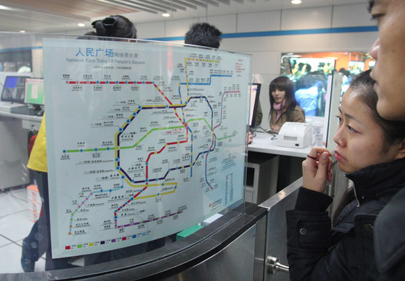 5 A resident in Shanghai looks at a map of the new metro lines.