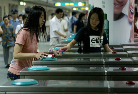 6 A passenger swipes a travel card before entering the subway.