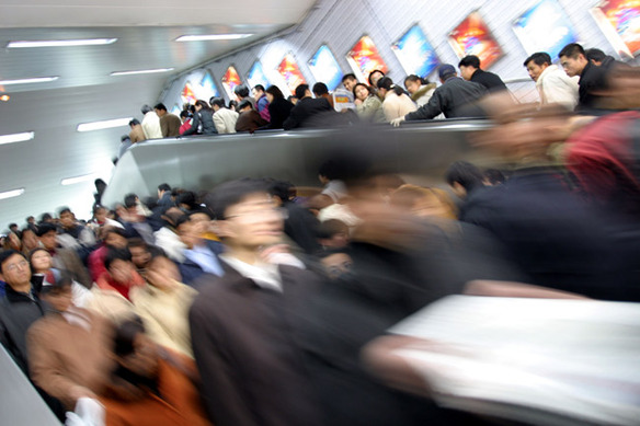 11 Passengers hurry through a subway station.