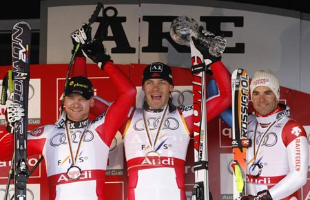 Michael Walchhofer of Austria (C) celebrates with his downhill crystal trophy with second placer Klaus Kroell of Austria (L) and third placer Didier Defago of Switzerland after the men's Downhill race at the Alpine Skiing World Cup Finals in Are March 11, 2009.