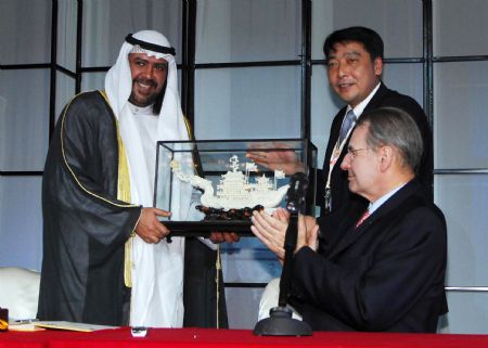 Xu Ruisheng (R. rear), Executive Deputy Secretary General of GAGOC (the Guangzhou Asian Games Organizing Committee) and Vice Mayor of Guangzhou, gives a gift to OCA (Olympic Council of Asia) President Sheikh Ahmad Al-Fahad Al-Sabah (L) next to International Olympic Committee (IOC) President Jacques Rogge during the oepning of the first OCA Sport Congress in Kuwait City March 12, 2009. (Xinhua)