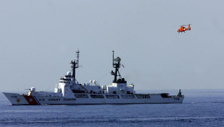 A U.S. naval helicopter takes off from a warship during a rescue operation at the Arabia Sea off the southern Pakistani port of Karachi, on Mar. 12, 2009. The rescue operation was part of the multinational AMAN 09 military exercises at the Arabia Sea. (Xinhua/Zha Chunming)