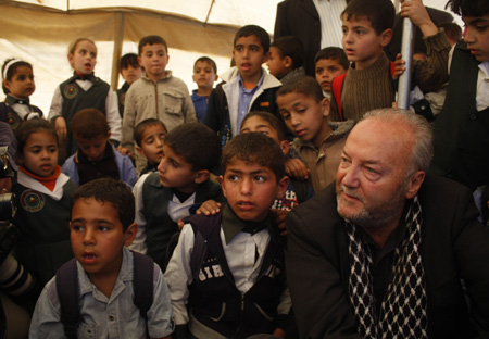 British lawmaker George Galloway (R) inspects the rubble of an Islamic school destroyed during January's Israeli military offensive in Rafah, southern Gaza Strip, March 11, 2009. An aid caravan headed by Galloway, carrying food, clothing and medicine entered Gaza from Egypt on Monday through Egypt's Rafah border crossing. 