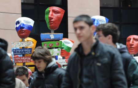 People pass by a group of creations featuring 27 masks with national colours of 27 EU member states in the European Parliament in Strasbourg, France, March 12, 2009. The creation was based on the mask of Roman Cavarly helmet unearthed in the ruins of the Teutonburg Forest Battle, which was a crucial fight between Germanic Tribes and Roman Empire occurred on 9 AD. The masks were created as a symbol of peace and of cooperation in the European region nowadays. (Xinhua/Wu Wei)