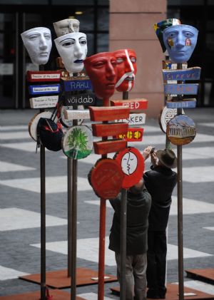 People view a group of creations featuring 27 masks with national colours of 27 EU member states in the European Parliament in Strasbourg, France, March 12, 2009. 