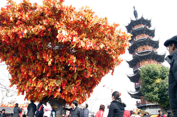 Well-wishers follow the tradition of throwing ribbons to the “Lucky Tree” on Lantern Festival, the fifteenth day of the Chinese Lunar New Year, hoping to be blessed with good fortune in the coming year.