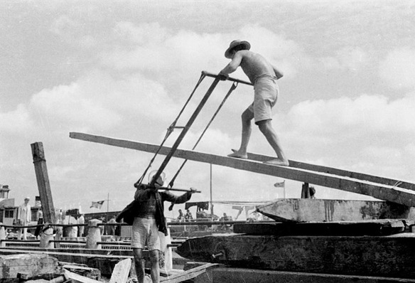 Workers sawing wood on a Shanghai dock in the 1930s