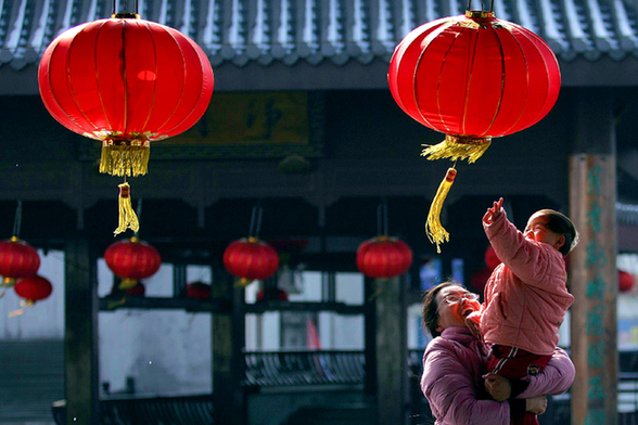 People touch lanterns in the air