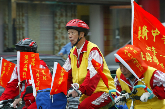 Senior citizens in Shanghai promote the 2010 World Expo by riding bicycles. 