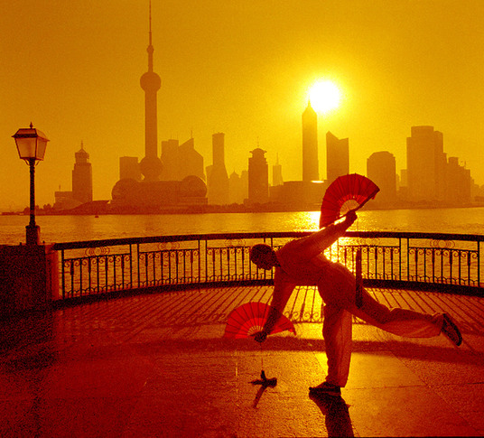 People doing morning exercises near the Oriental Pearl Tower at Lujiazui. 