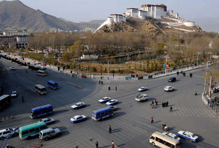 Vehicles run on a crossroad in Lhasa, capital of southwest China's Tibet Autonomous Region, on March 14, 2009. The holy city of Lhasa was quiet Saturday, the first anniversary of the riots that killed 18 civilians and a police officer.[Xinhua]