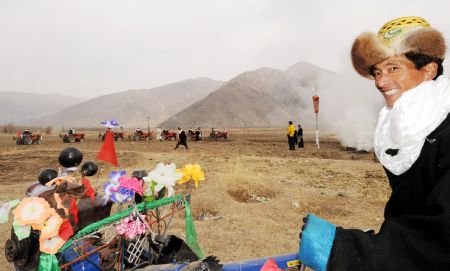 A local villager in traditional costumes attends a ceremony to mark the start of the spring farming season at Dagze County, southwest China's Tibet Autonomous Region, March 15, 2009. [Chogo/Xinhua]