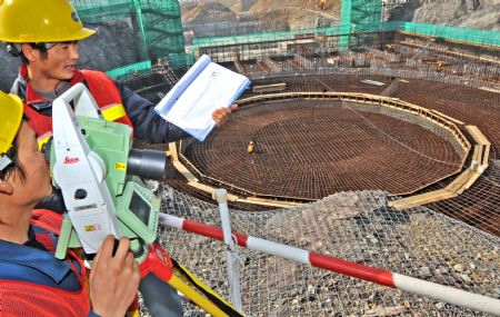 Technicians make measurements at a construction site of the Sanmen Nuclear Power Project (NPP) in east China's Zhejiang Province, March 15, 2009. The first phase of the Sanmen NPP is now ready for startup. [Tan Jin/Xinhua] 
