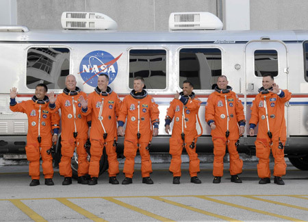 Space shuttle Discovery astronauts (L-R) Koichi Wakata of Japan, John Phillips, Richard Arnold, Steve Swanson, Joseph Acaba, Pilot Tony Antonelli and Mission Commander Lee Archambault leave their crew quarters for launch pad 39A at the Kennedy Space Center in Cape Canaveral, Florida March 15, 2009. [Xinhua]