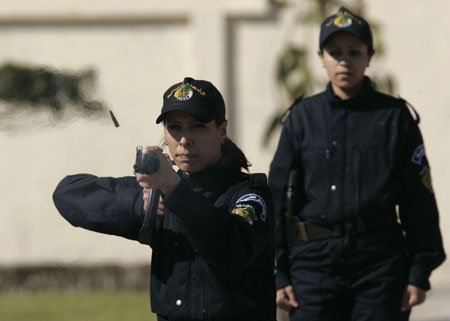 Newly graduated female members of a police special unit perform during their graduation ceremony at the police academy in Ain Benian, Algiers, March 15, 2009. [Xinhua/Reuters]