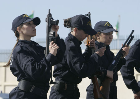 Newly graduated female members of a police special unit hold their weapons during their graduation ceremony at the police academy in Ain Benian, Algiers, March 15, 2009. [Xinhua/Reuters]