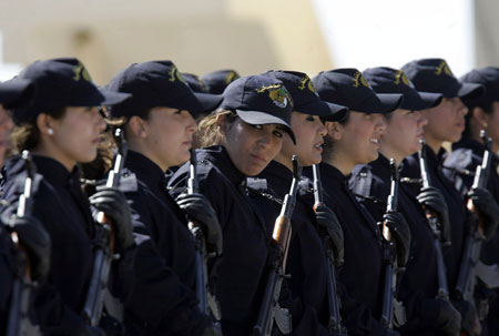 Newly graduated female members of the police special unit march during their graduation ceremony at the police academy in Ain Benian, Algiers March 15, 2009. [Xinhua/Reuters]