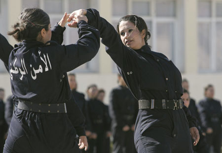 Newly graduated female members of a police special unit perform during their graduation ceremony at the police academy in Ain Benian, Algiers, March 15, 2009. [Xinhua/Reuters]