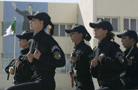 Newly graduated female members of a police special unit run during their graduation ceremony at the police academy in Ain Benian, Algiers, March 15, 2009. [Xinhua/Reuters]