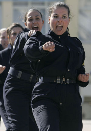 Newly graduated female members of a police special unit perform during their graduation ceremony at the police academy in Ain Benian, Algiers, March 15, 2009. [Xinhua/Reuters]