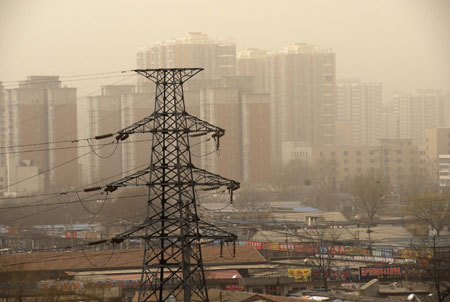 Towering buildings in the city proper are hazed by floating dust, as the first 'yellow dust' storm of this year shrouds the urban areas after northerly wind blew in sand from drought-hit northern China exacerbating the yellowish sky, in Beijing, March 15, 2009. The sand came from Inner Mongolia Autonomous Region, Gansu and Qinghai provinces, where sandstorms raged earlier this week after prolonged drought, according to the Central Meteorological Bureau. [Wang Huaigui/Xinhua]